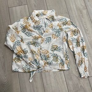 Collared top, v-neck with front button closure and bottom tie closure.